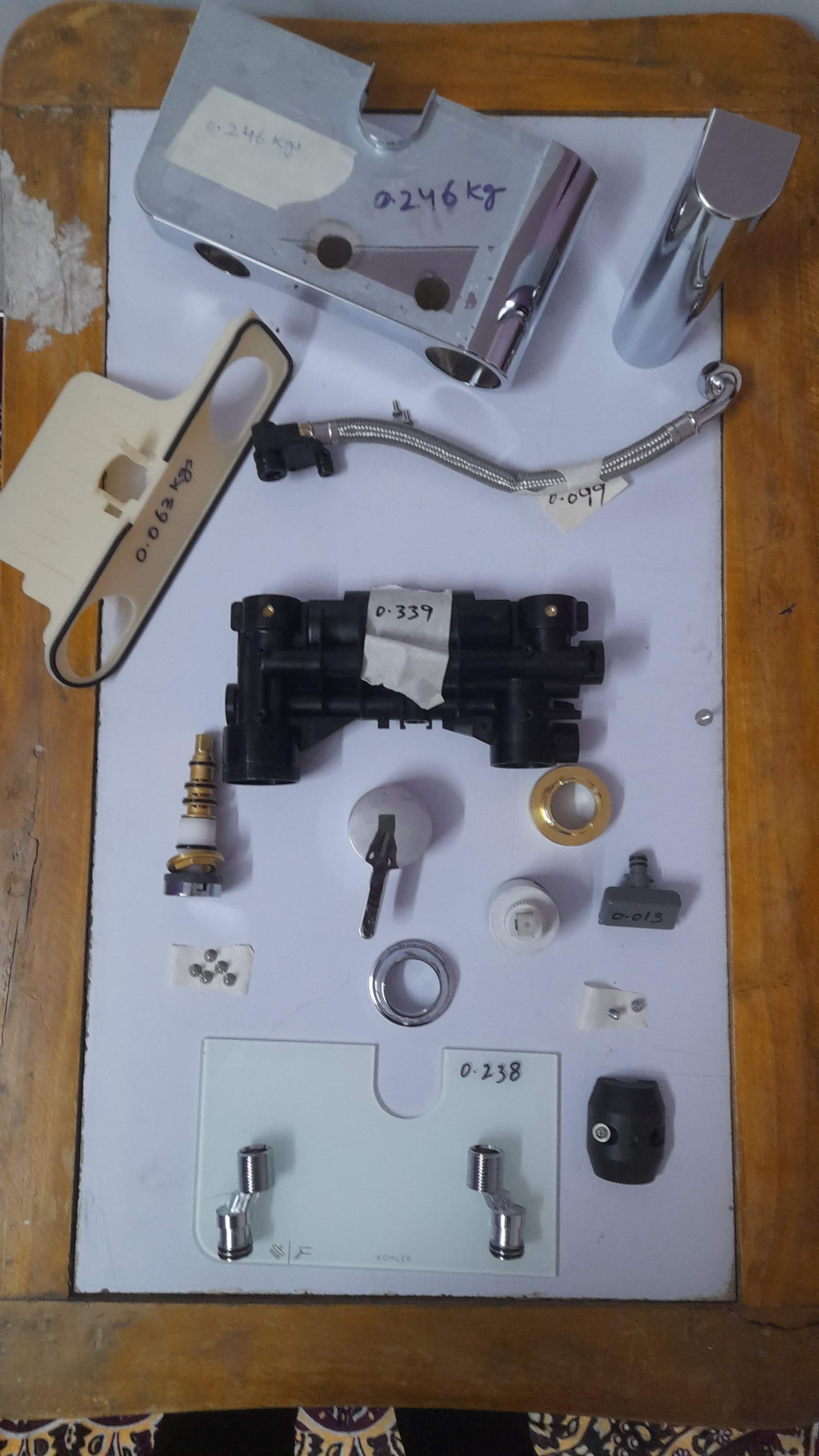 Disassembled product components arranged for teardown benchmarking